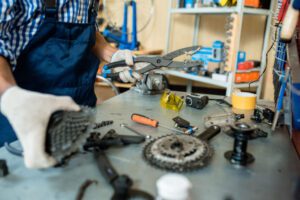 mechanic working on bicycle parts in workshop